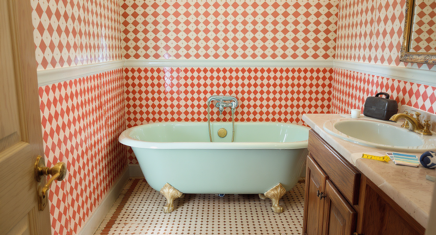 A photorealistic vintage bathroom with a pastel tub, bold wallpaper, mismatched cabinets, and renovation tools, evocative of 'dated' charm.