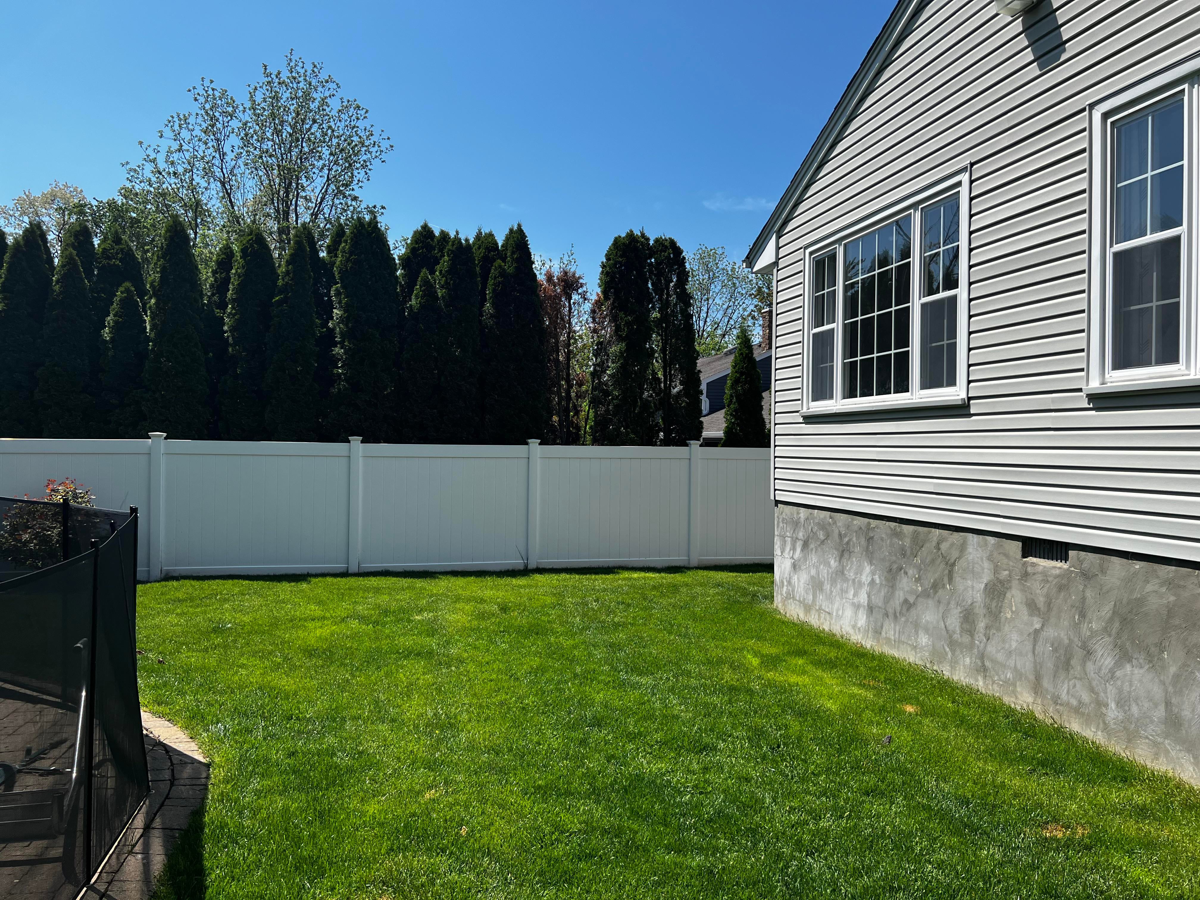 Curved pathway leading to a side yard archway