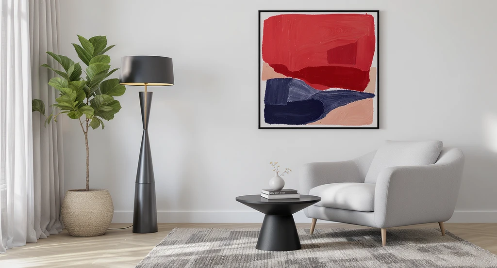 Modern living room corner with a tall black floor lamp, low gray armchair, large abstract wall art, and a potted plant—demonstrating how to furnish an empty room from scratch and creative ideas for empty living room spaces by transforming awkward layouts into functional spaces using a step by step guide to room design and showing what furniture to buy for open plan rooms.