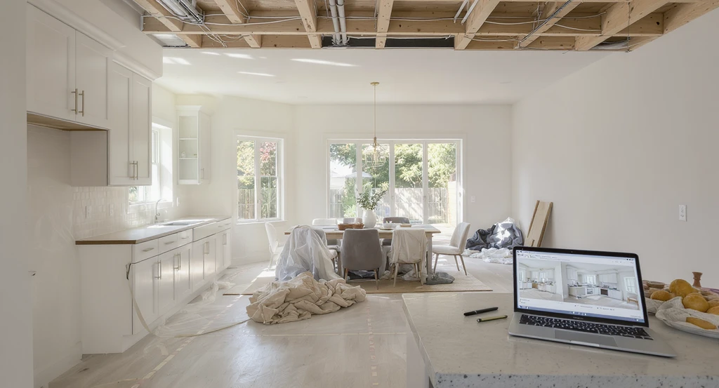 Editorial-style, photorealistic kitchen mid-remodel with wall removed between kitchen and dining area, showing ai kitchen remodel visualization tool in use, virtual staging, and live color scheme suggestions for modern home renovation.