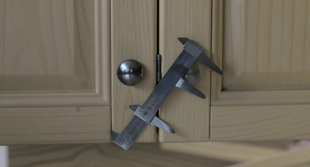 Evenly spaced kitchen cabinet doors and drawers in a galley kitchen, showing a precise 1/8-inch clearance as part of how to decide whether to paint kitchen cabinets and structural checks before painting cabinets.