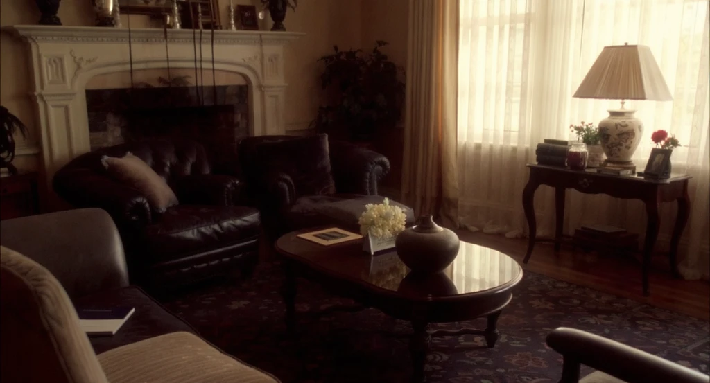 Editorial photo of a terracotta living room with a brown sofa, brown curtains, and a rug too similar in color to the walls and furniture, showing how rug choice can impact room appearance and highlighting rug color ideas for brown sofa and terracotta walls.