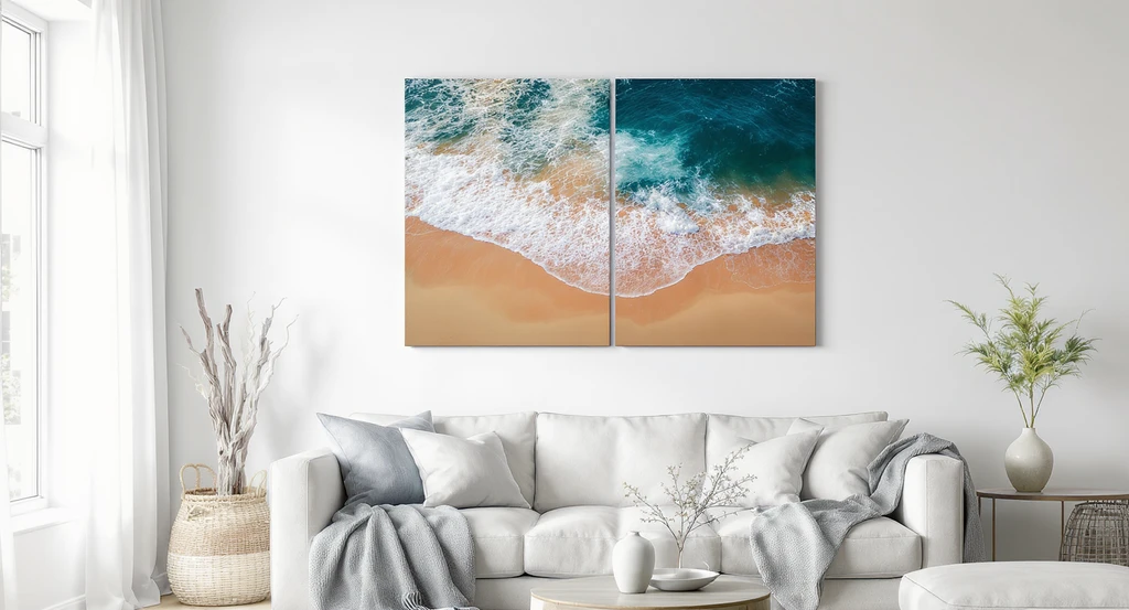 Modern living room showcasing two large aerial beach prints above a sofa—one with sand at the top, one at the bottom—to illustrate how artwork orientation impacts room layout and spatial harmony.