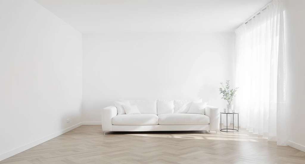 Pristine white living room with white walls, sofa, sheer curtains, and pale floors, showing a sterile home interior lacking warmth or personality.