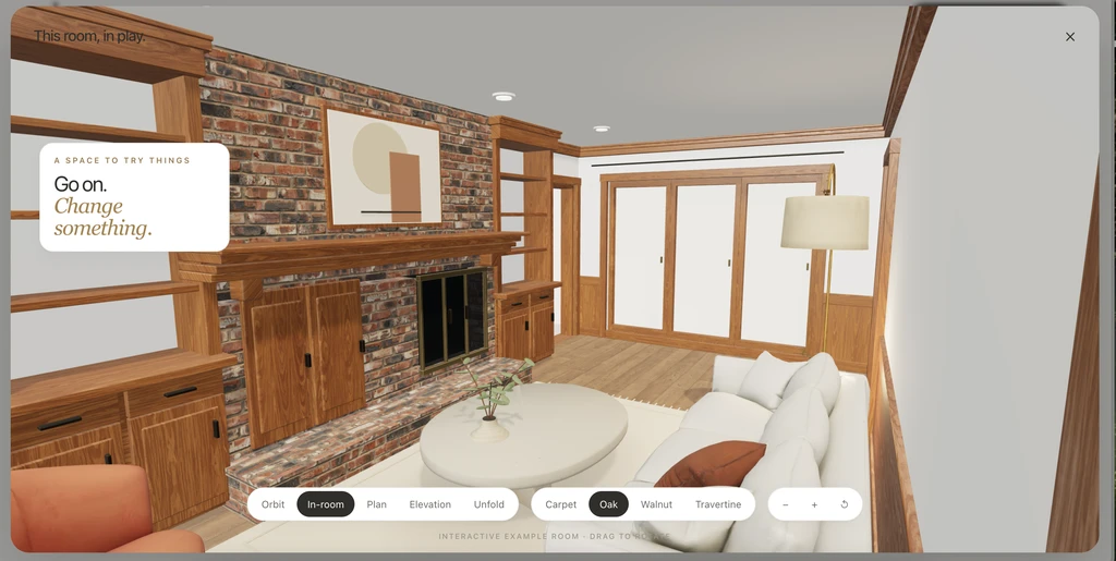 Chez interactive example room with a brick fireplace, wood shelving, white sofa, and oak flooring, shown in In-room mode.