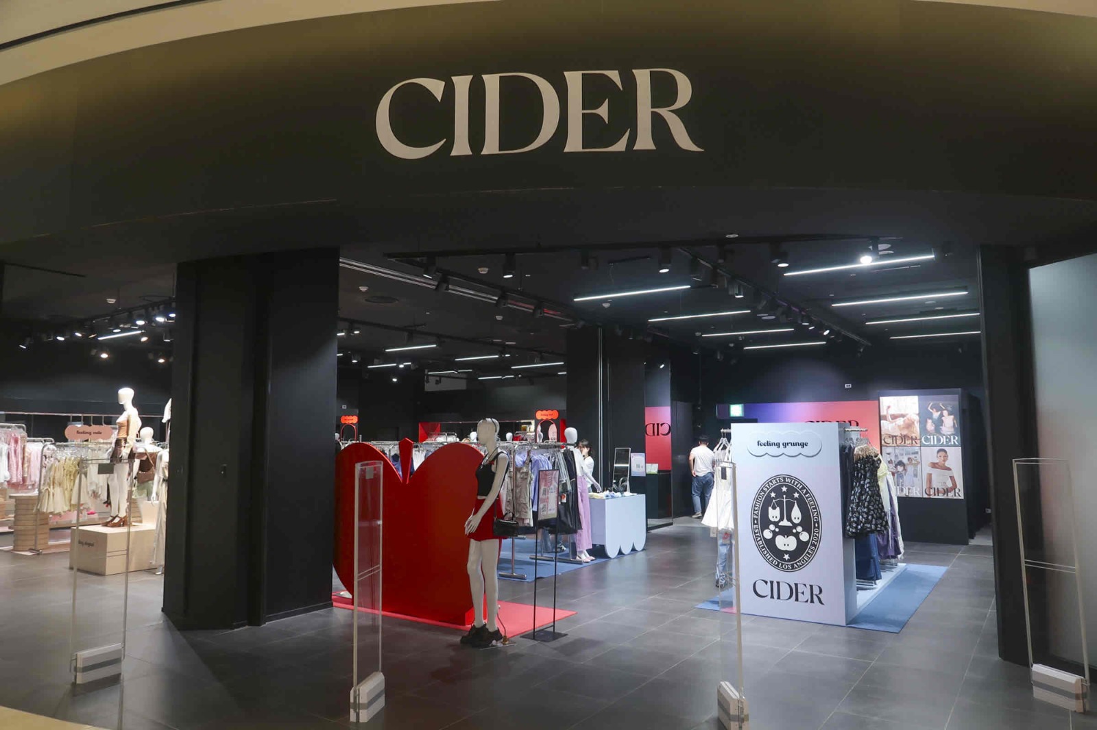 CIDER pop-up storefront in Seoul with branded apple and crest displays