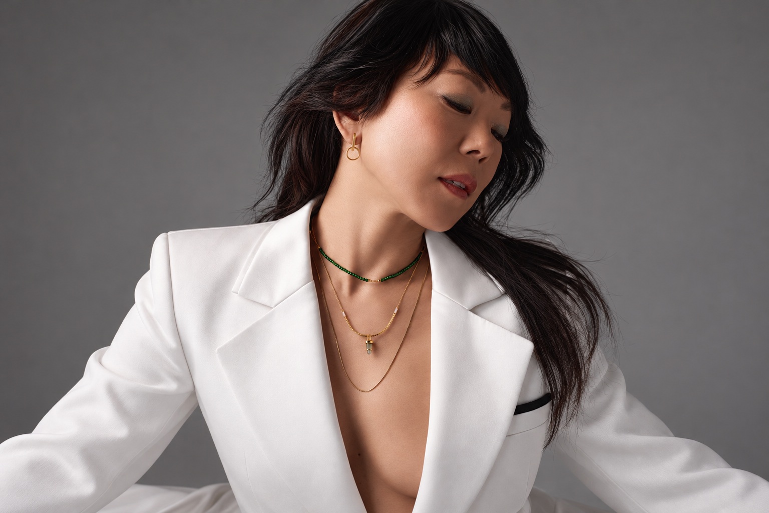 Actress Ali Ahn with her face, gold earring and layered Bliss Lau jade necklaces visible