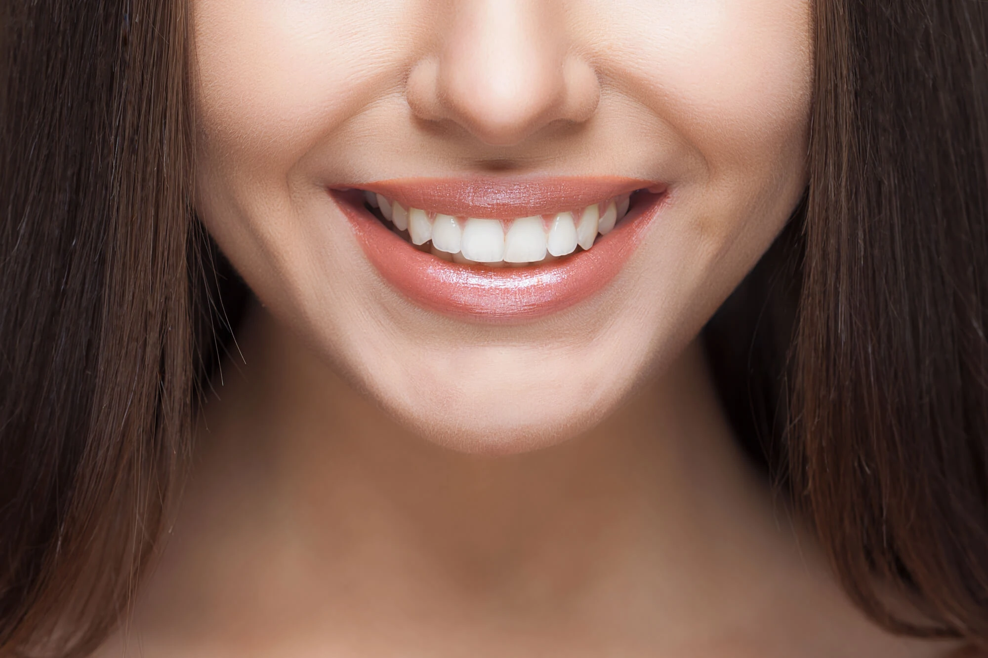 lose-up of a patient smiling to show healthy teeth for full mouth reconstruction treatment