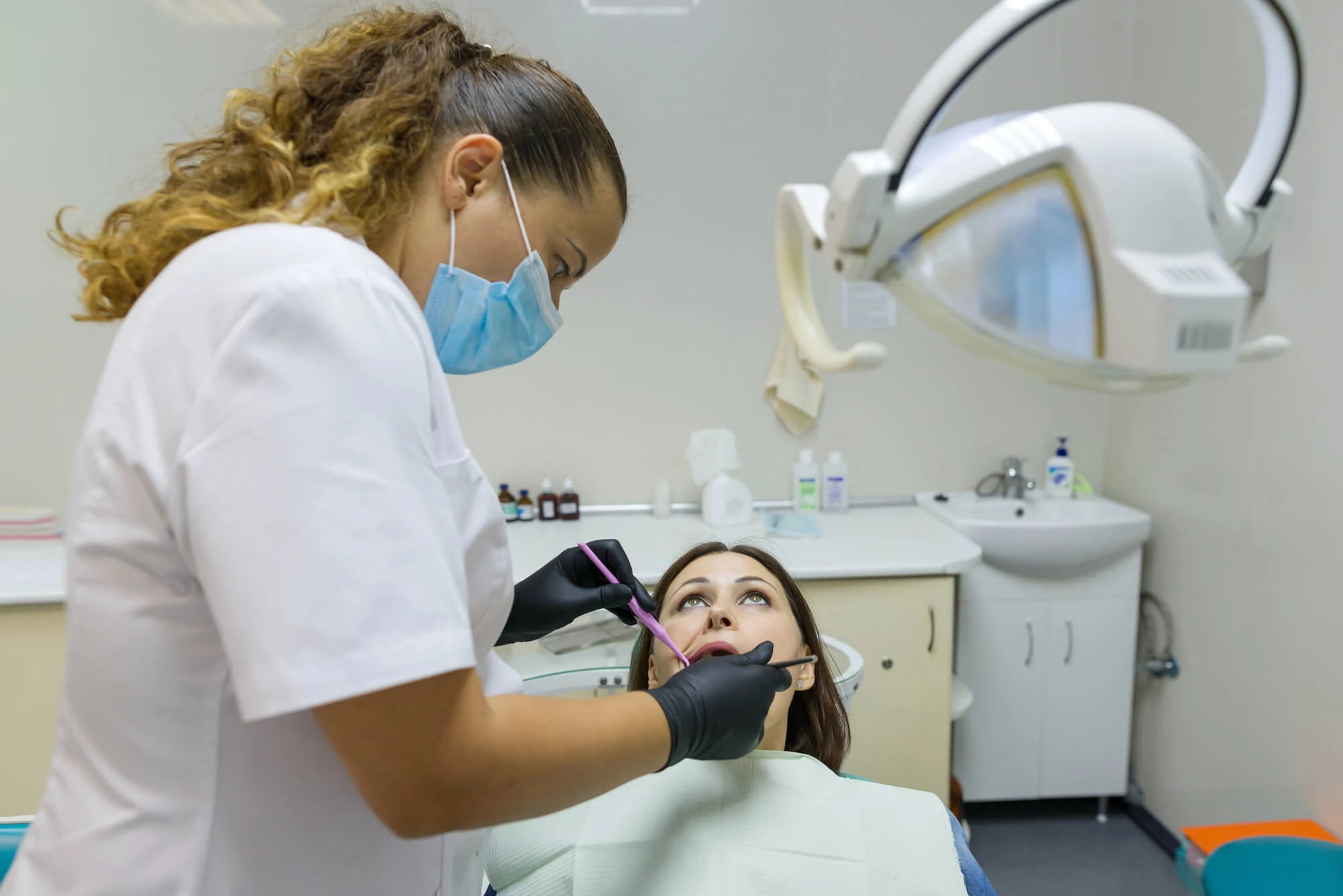 Dental professional examining a patient during a sedation dentistry Lexington visit