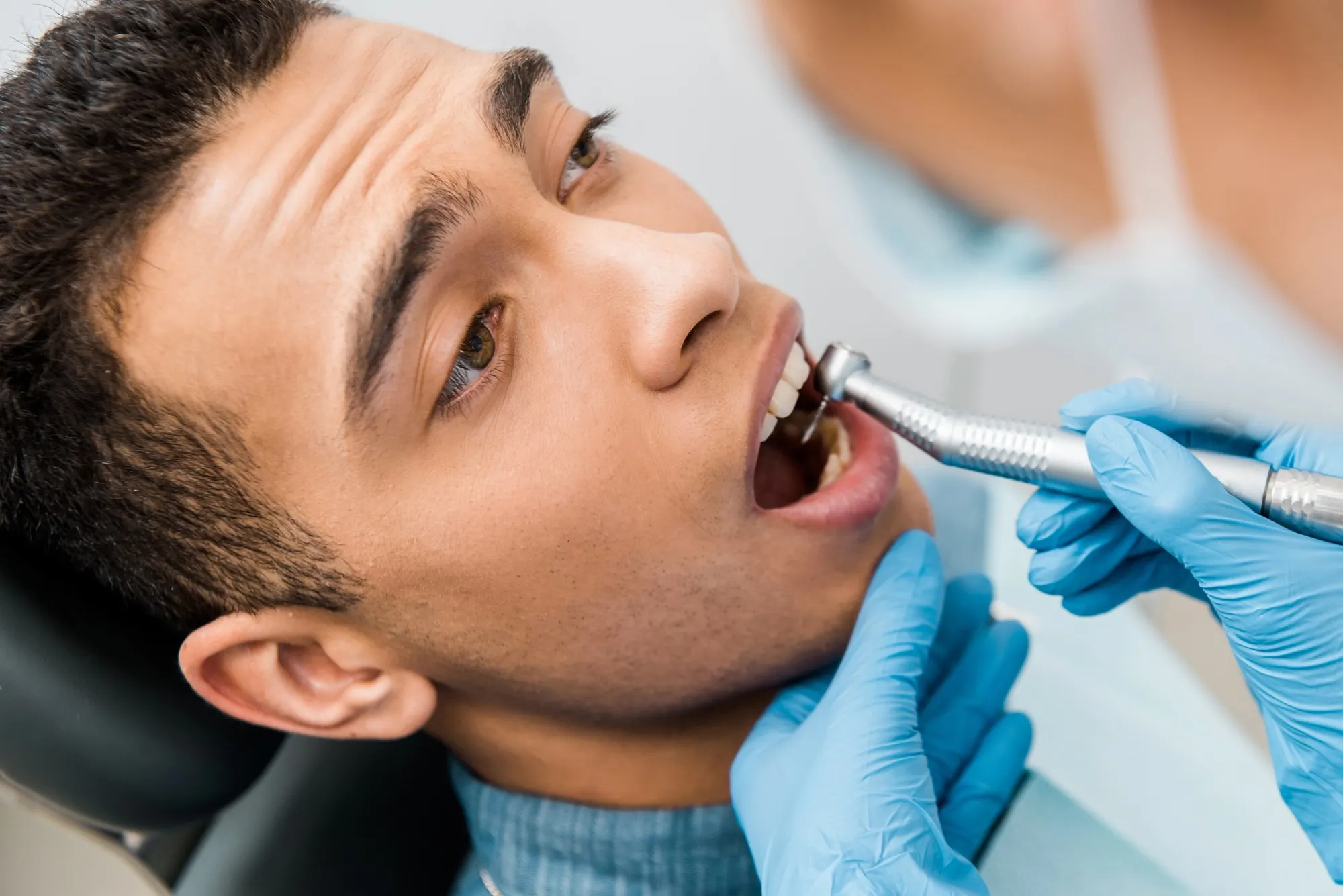 Emergency dentist in Lexington examining a patient with a dental drill during urgent dental care