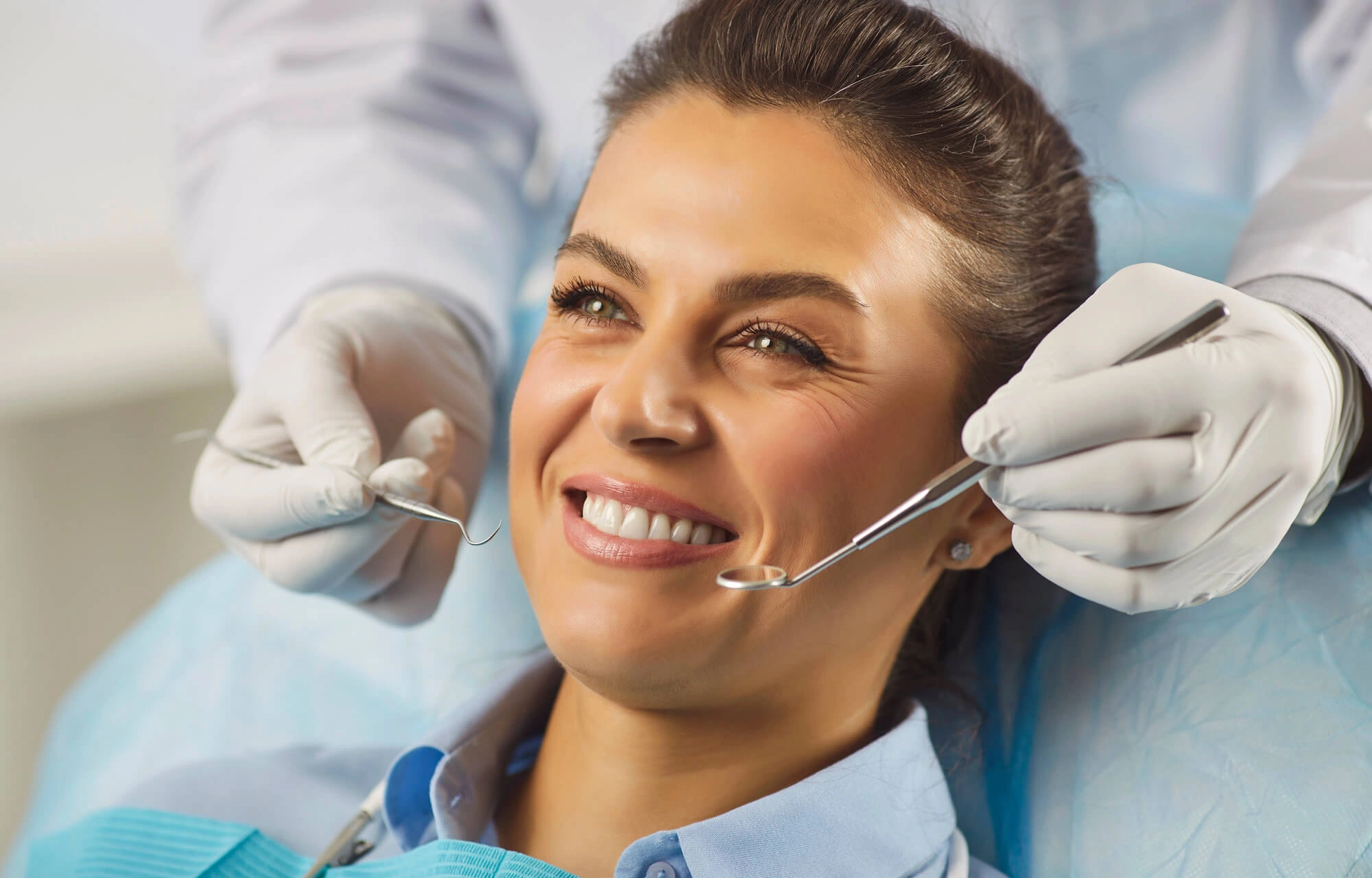 dentist examining Permanent Dental Implants