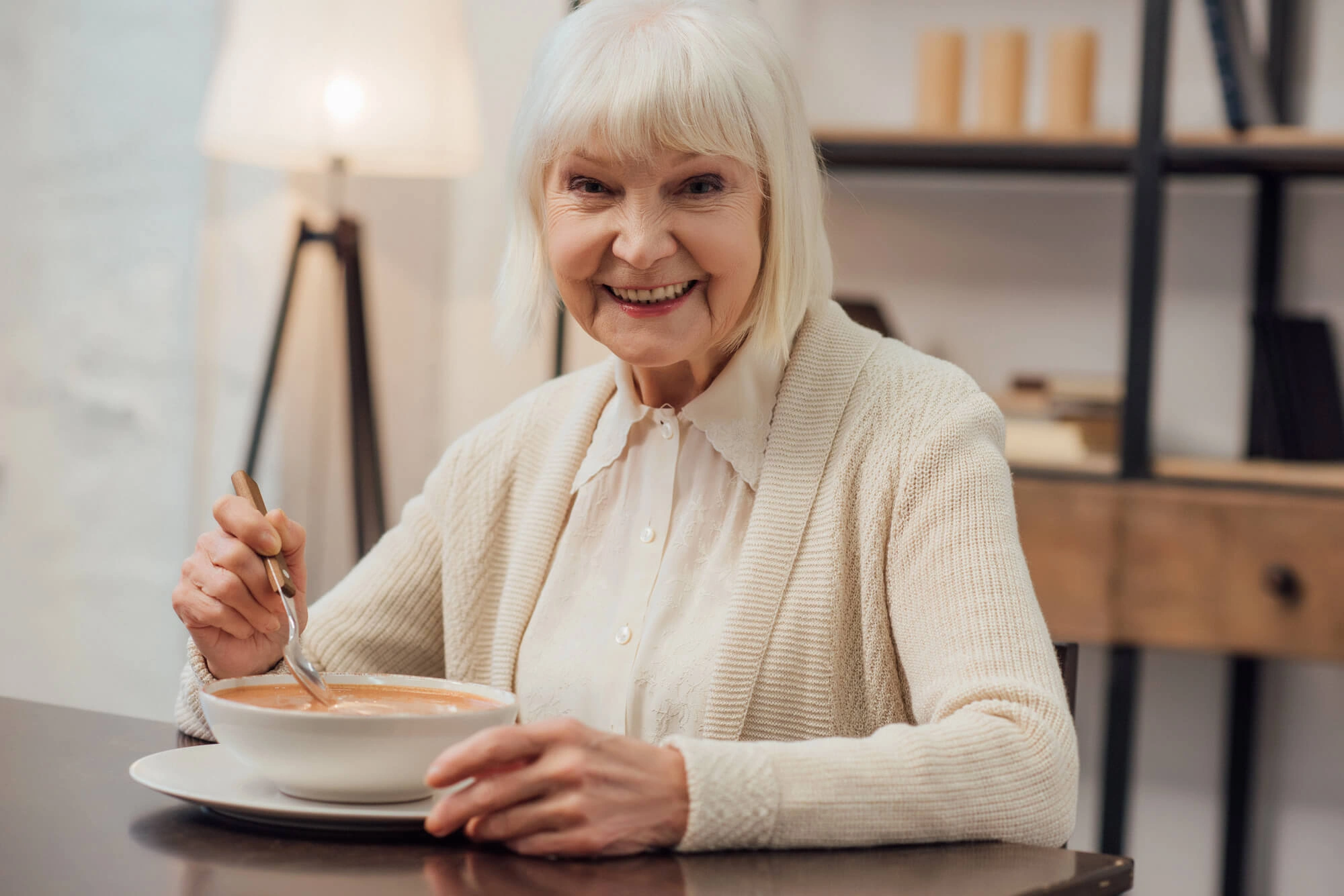 senior enjoying soup with Same Day Dentures in Lexington KY