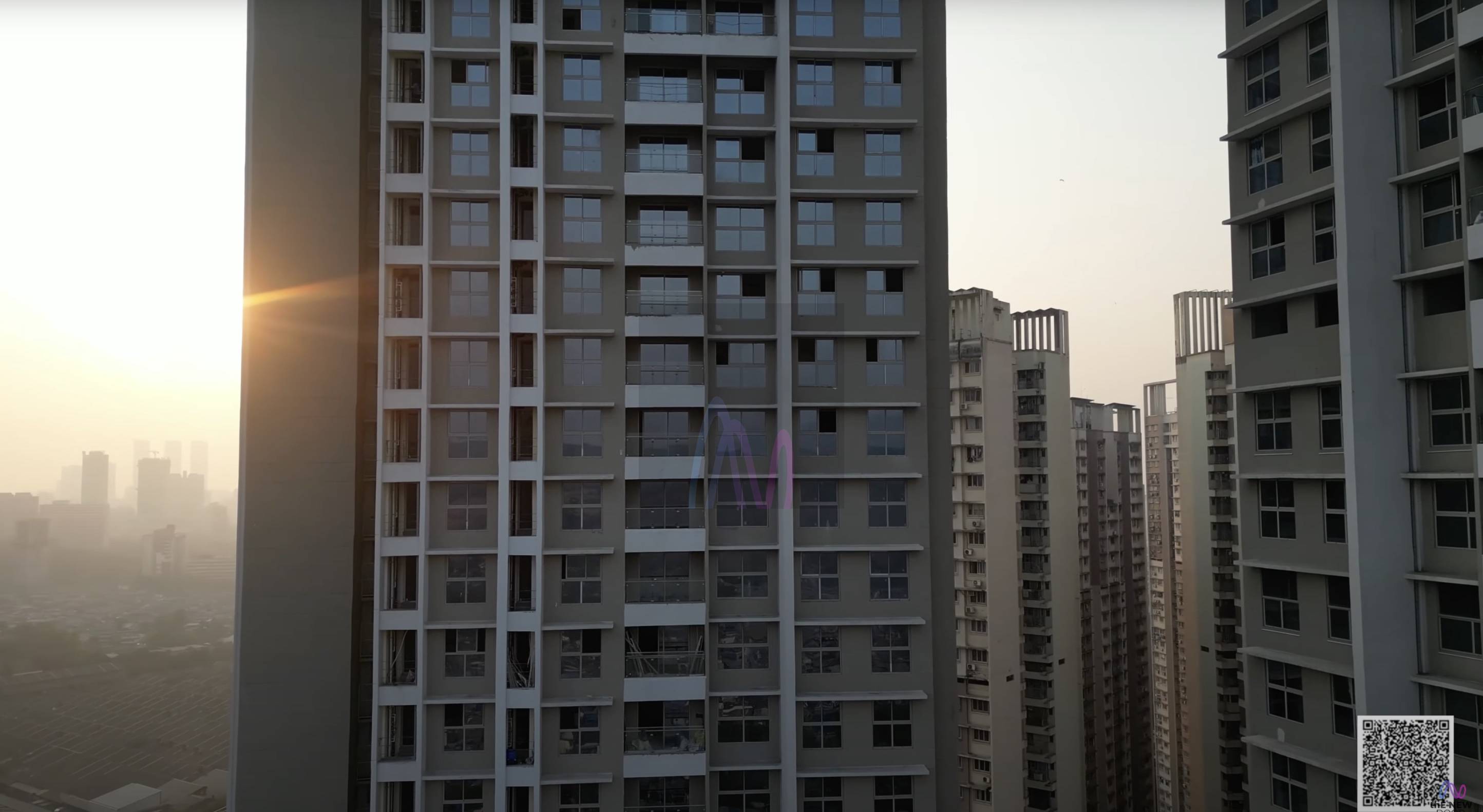 Morning sun behind a residential high-rise in Mumbai's suburbs