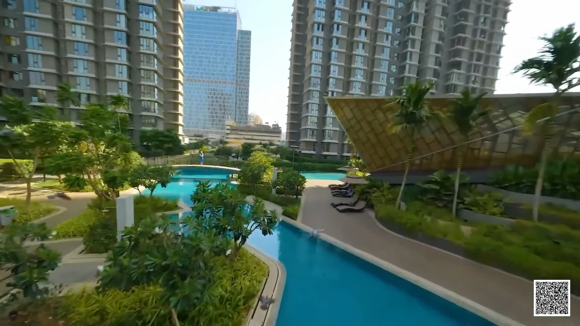 Swimming pool and landscaped garden between residential towers in the Mumbai region
