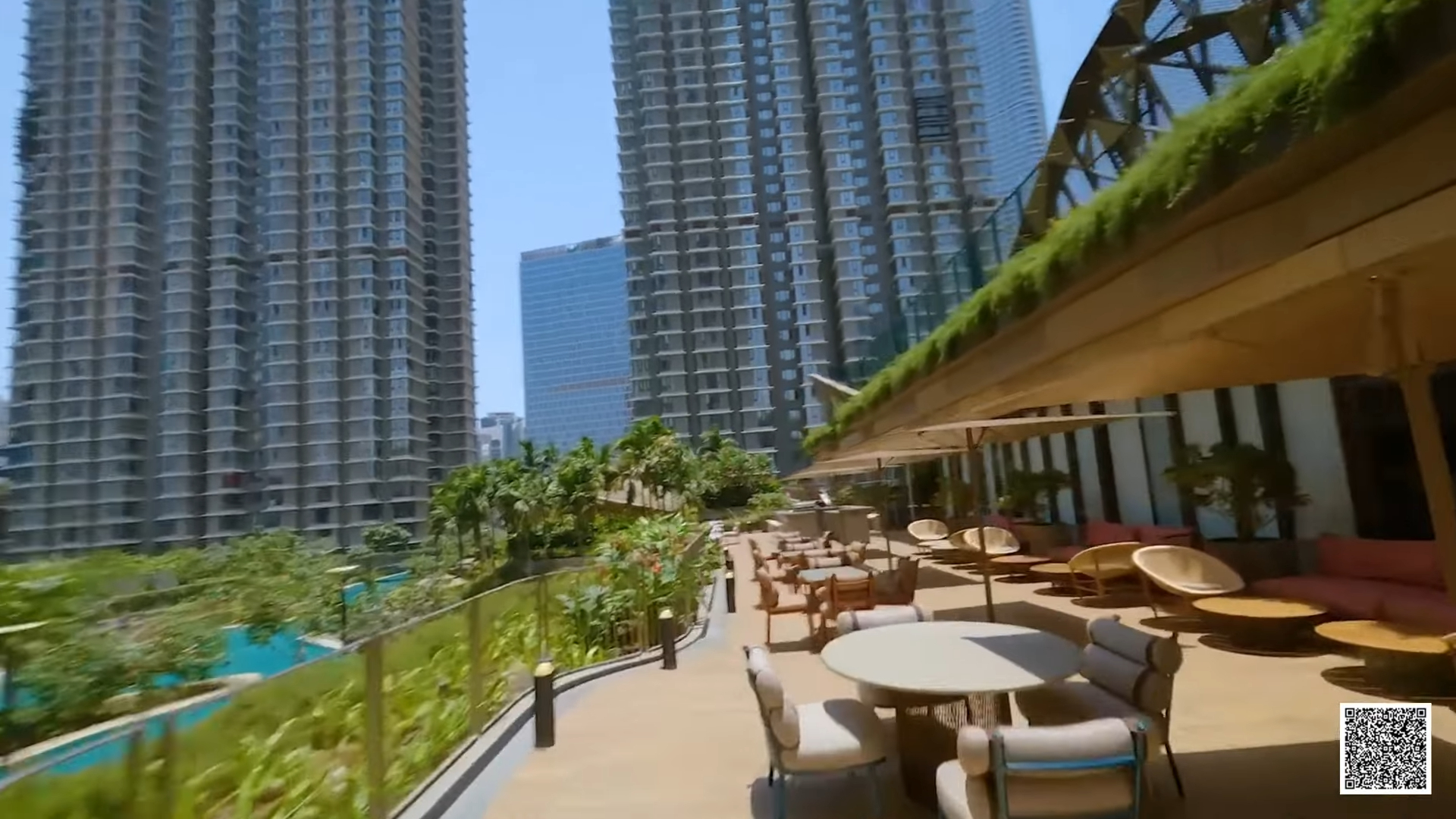 Podium deck with seating and a pool between new residential towers
