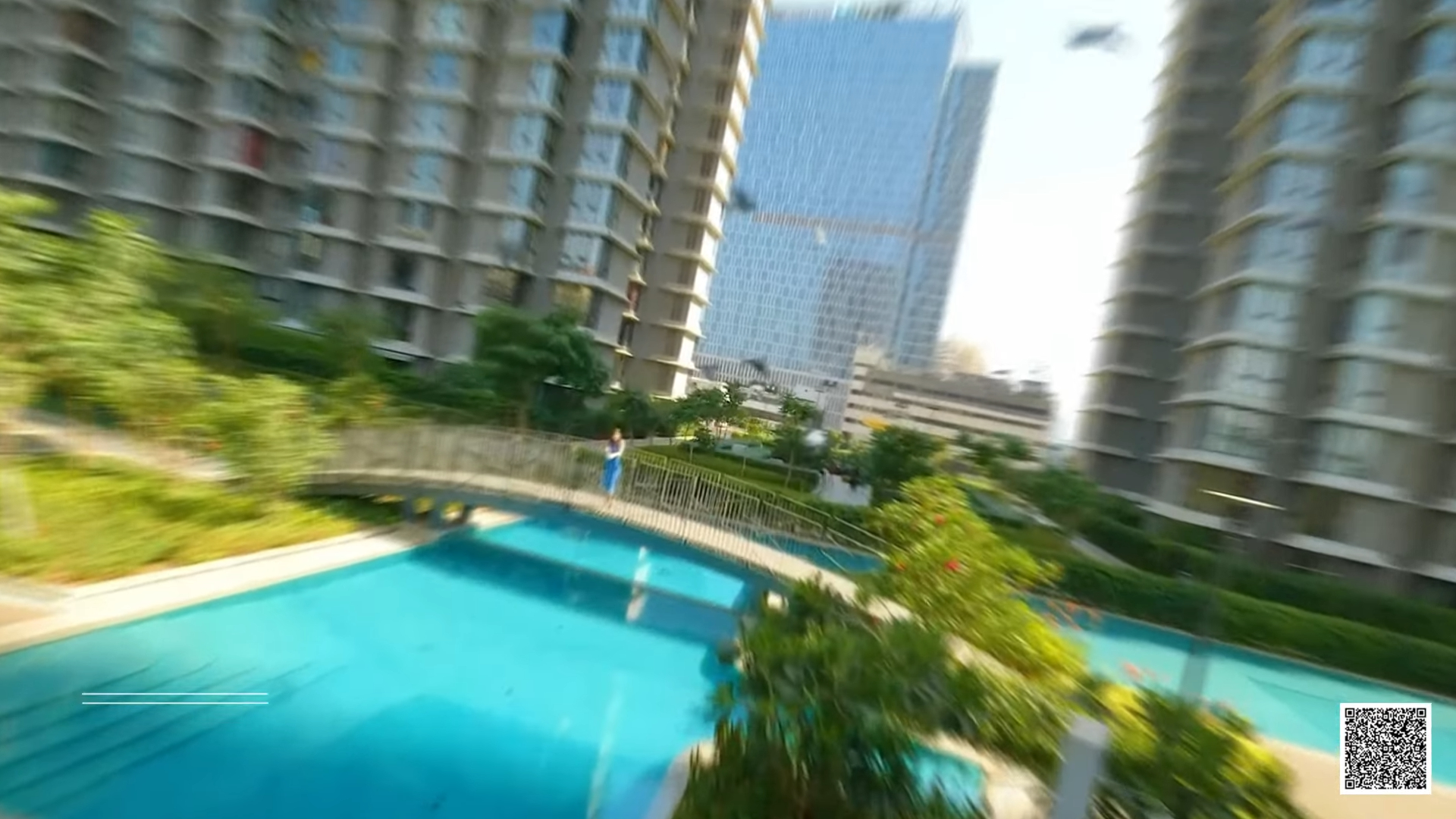 Swimming pool and landscaped walkway between residential towers in Mumbai