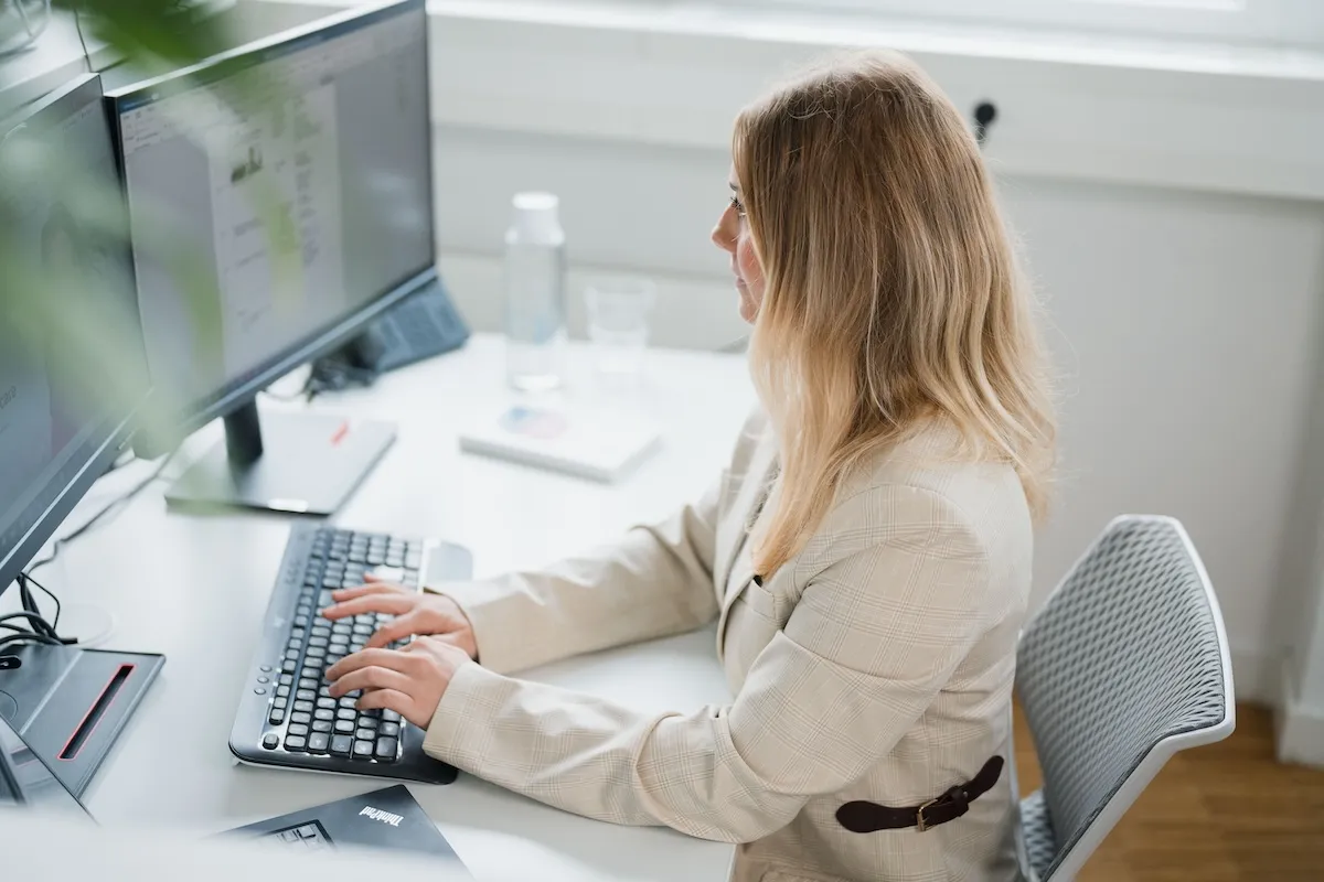 person is sitting on a computer