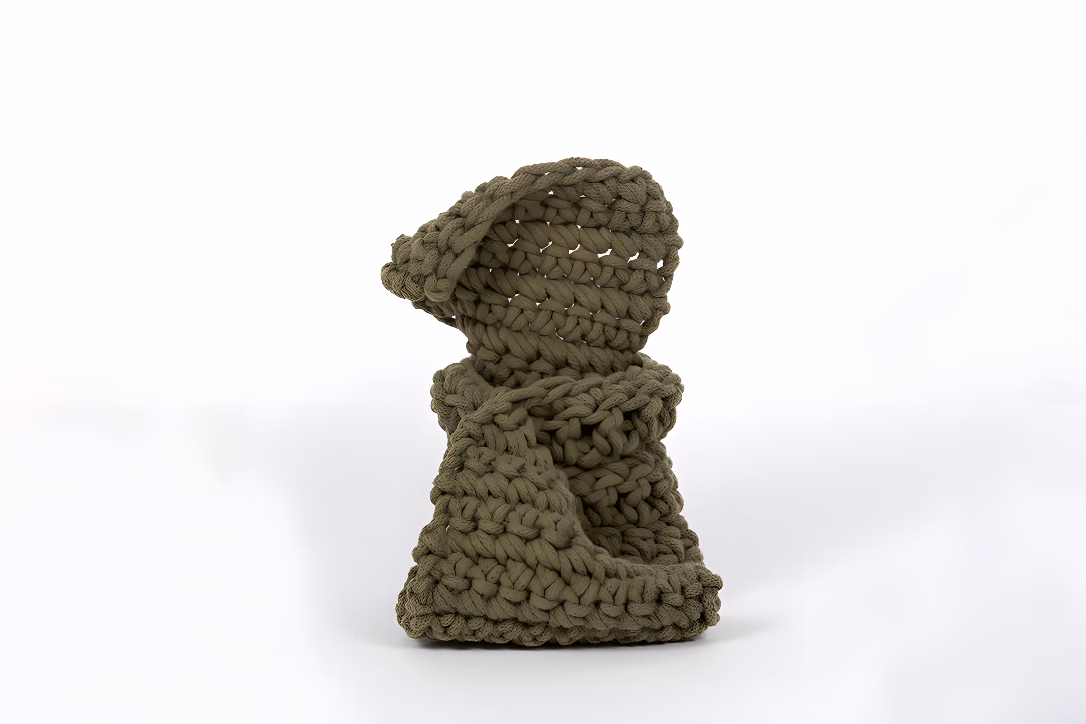 Handcrafted green knitted hooded scarf with thick yarn on a white background.
