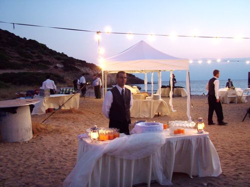 Waiter with welcome drinks at a beach wedding
