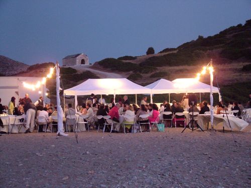 Guests chatting at a beach wedding