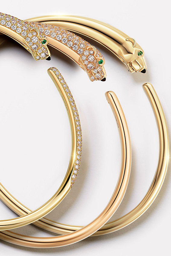 Cartier Panthère bracelets in yellow gold and diamond pavé, symbols of French elegance and fine jewelry artistry.