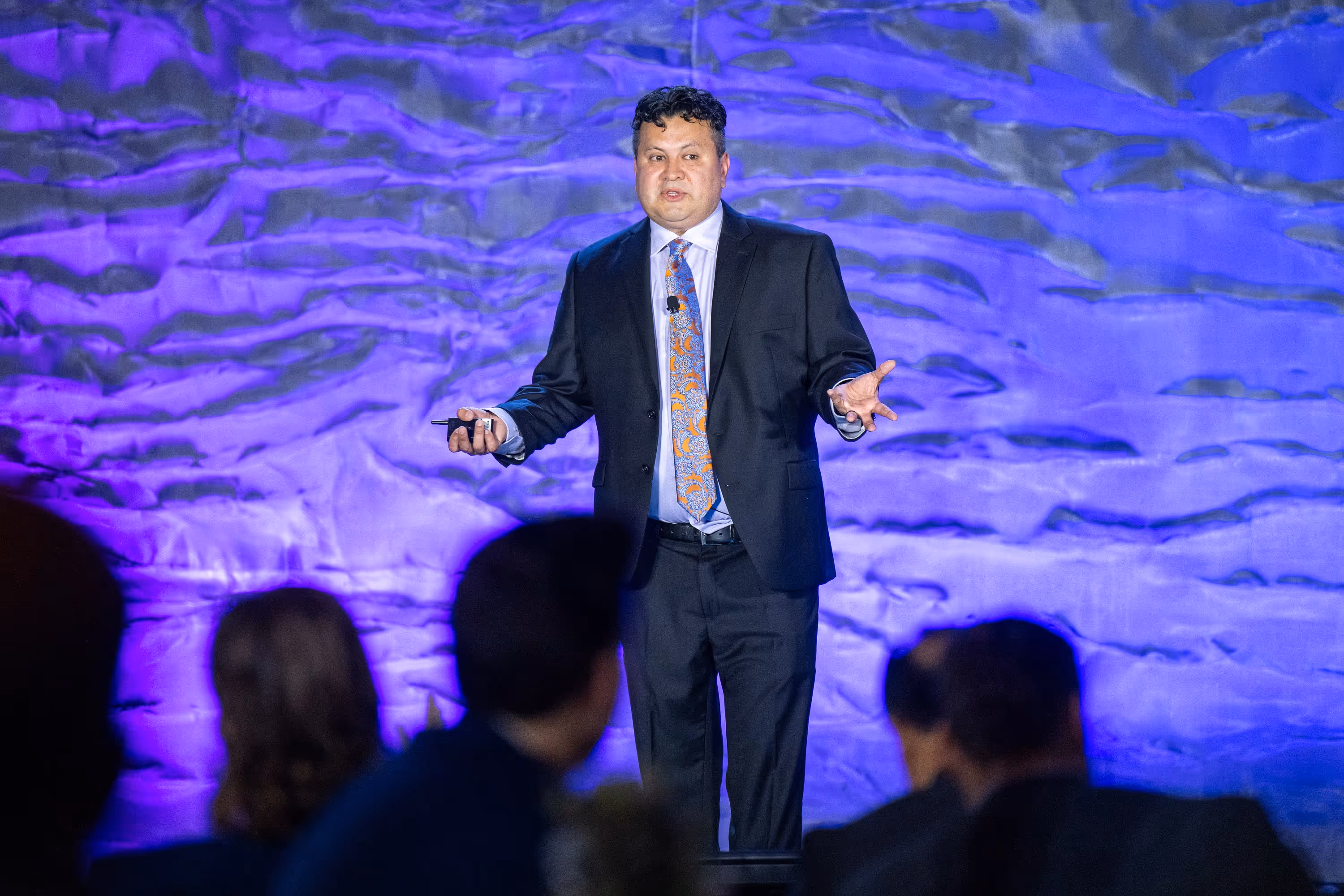 Dr. Harvey Castro delivering a keynote presentation on stage