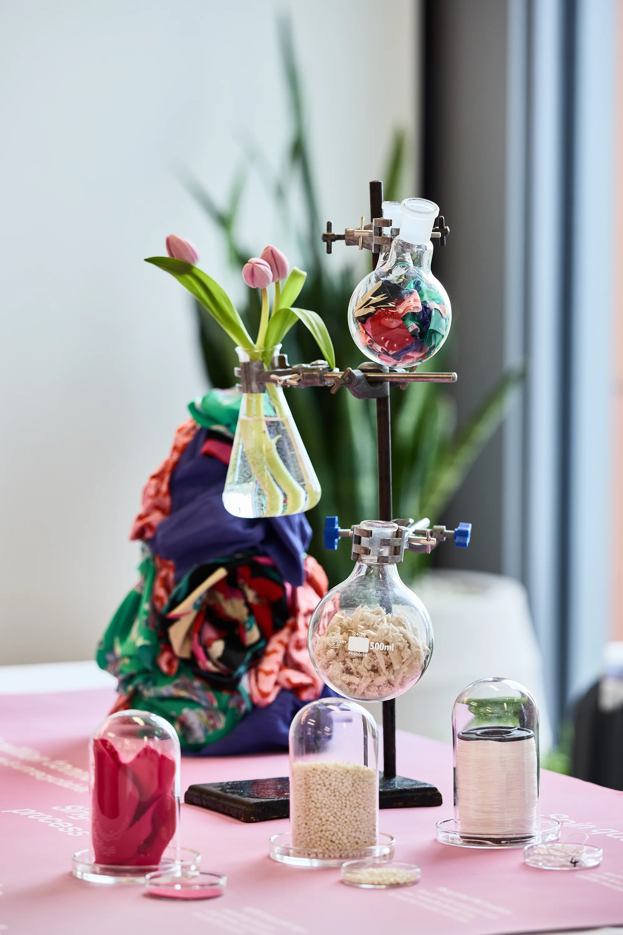 A photo with a decorative chemistry stand featuring different types of decolored fibres.