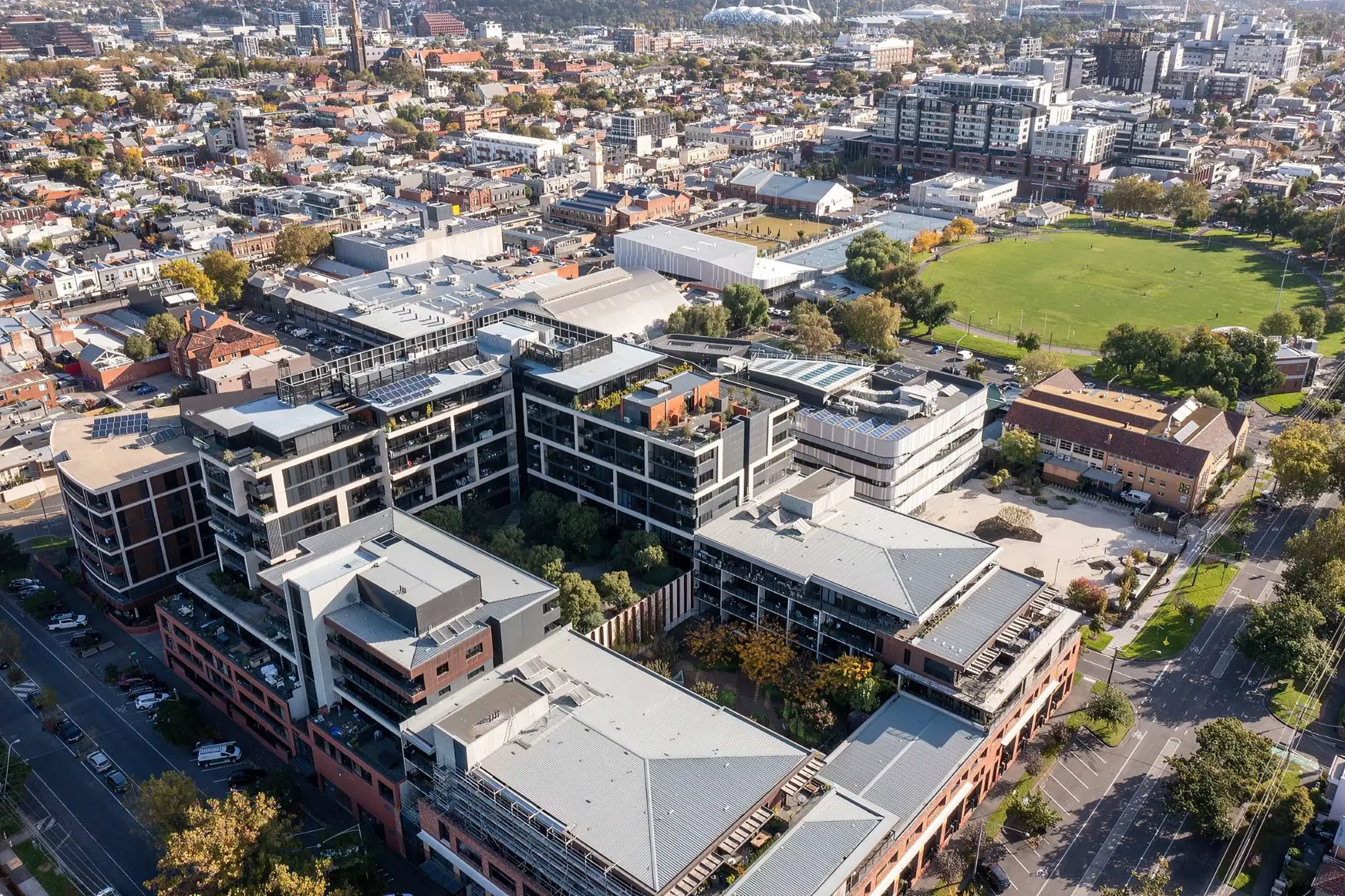 Aerial view of urban neighborhood with modern buildings and green spaces