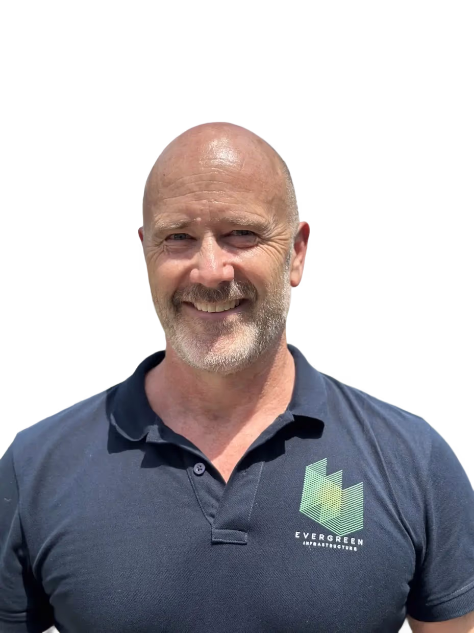 Smiling middle-aged bald man in Evergreen Infrastructure polo shirt