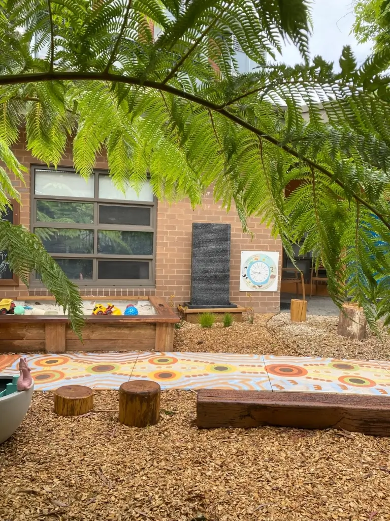 School outdoor play area with several plants scattered around 
