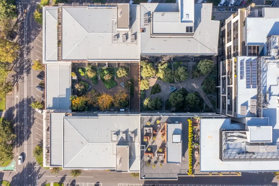 Drone shot of an apartment complex courtyard garden