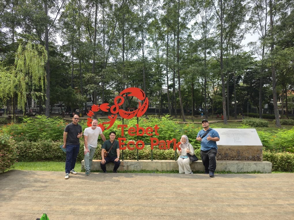 Michael Casey, Anton Siura and Malaysian landscape architect colleagues standing at the Tebet Eco Park entrance sign, Jakarta.