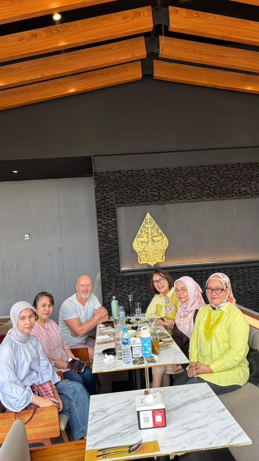 Michael Casey seated at a lunch meeting with Karen Tambayong and colleagues from Indonesia's landscape and horticulture industries.