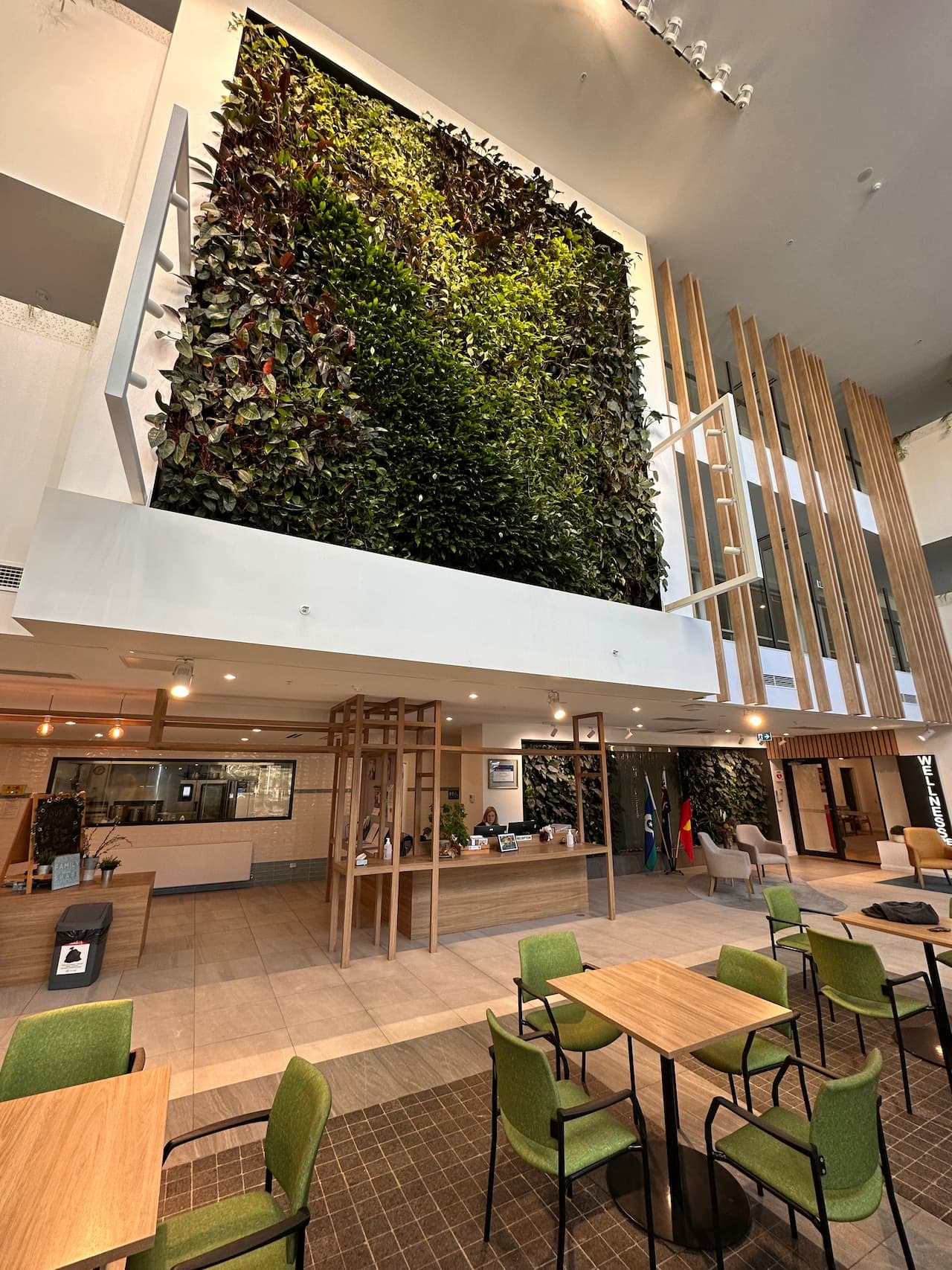 Modular green wall panels in a corporate atrium breakout area, a system type tested for sound absorption