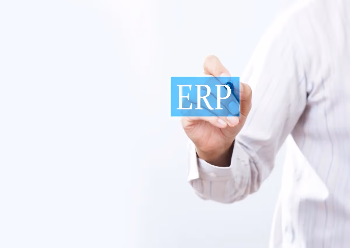 A person in a business shirt holds a card with "erp" text, symbolizing enterprise resource planning, against a blurred light background.