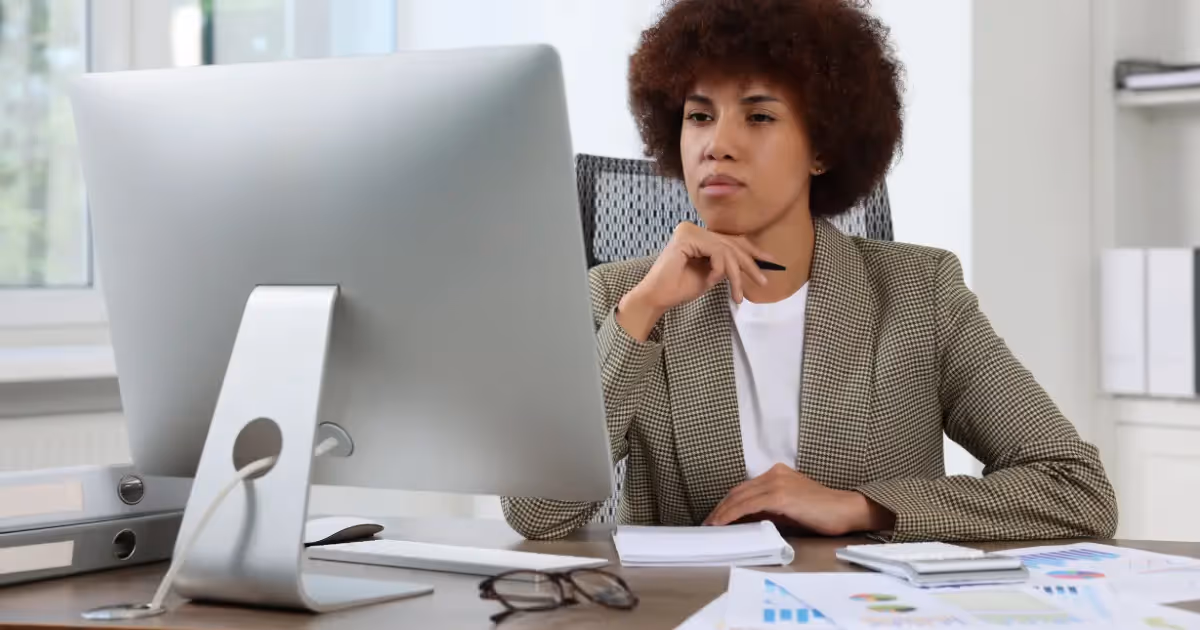accountant working on computer with a focused expression