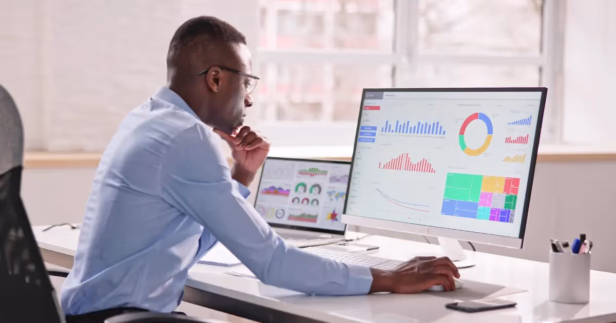 person on a computer looking at a software dashboard