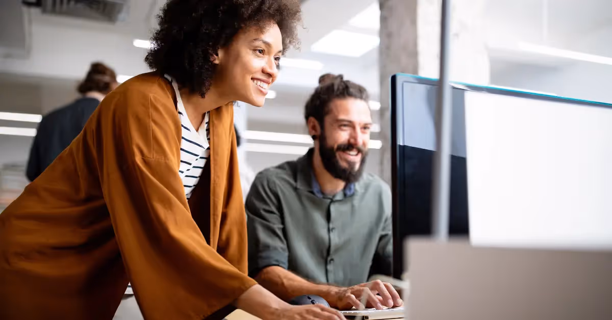 an accountant sitting at her desk smiling at the camera 