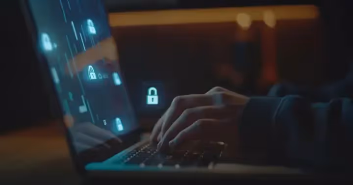 A person typing on a laptop with graphics of locks on the screen representing a locked document