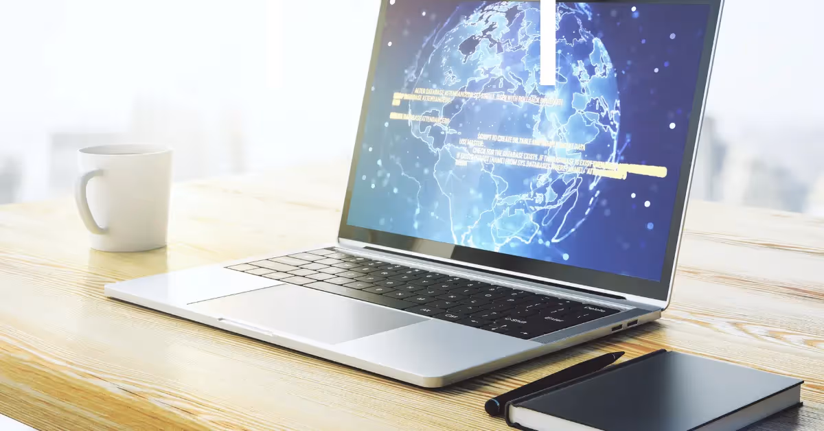 A laptop with a digital global map on the screen, representing cloud-based software and globally distributed teams