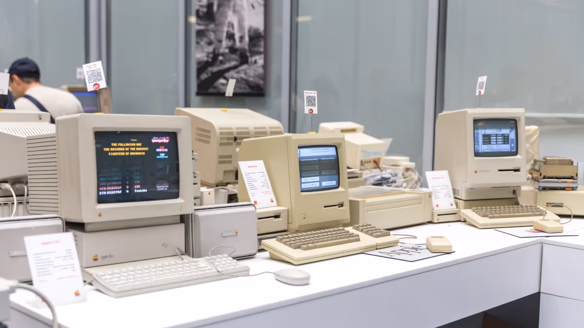 A large desk with early PCs