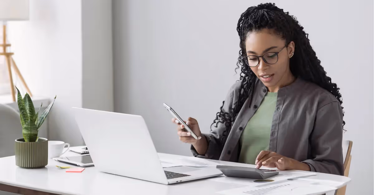Accountant at her desk using a calculator