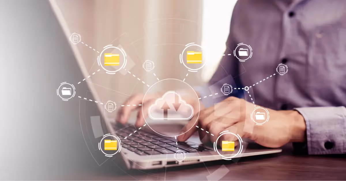 A person working on a laptop overlaid with graphics denoting connected cloud software and files