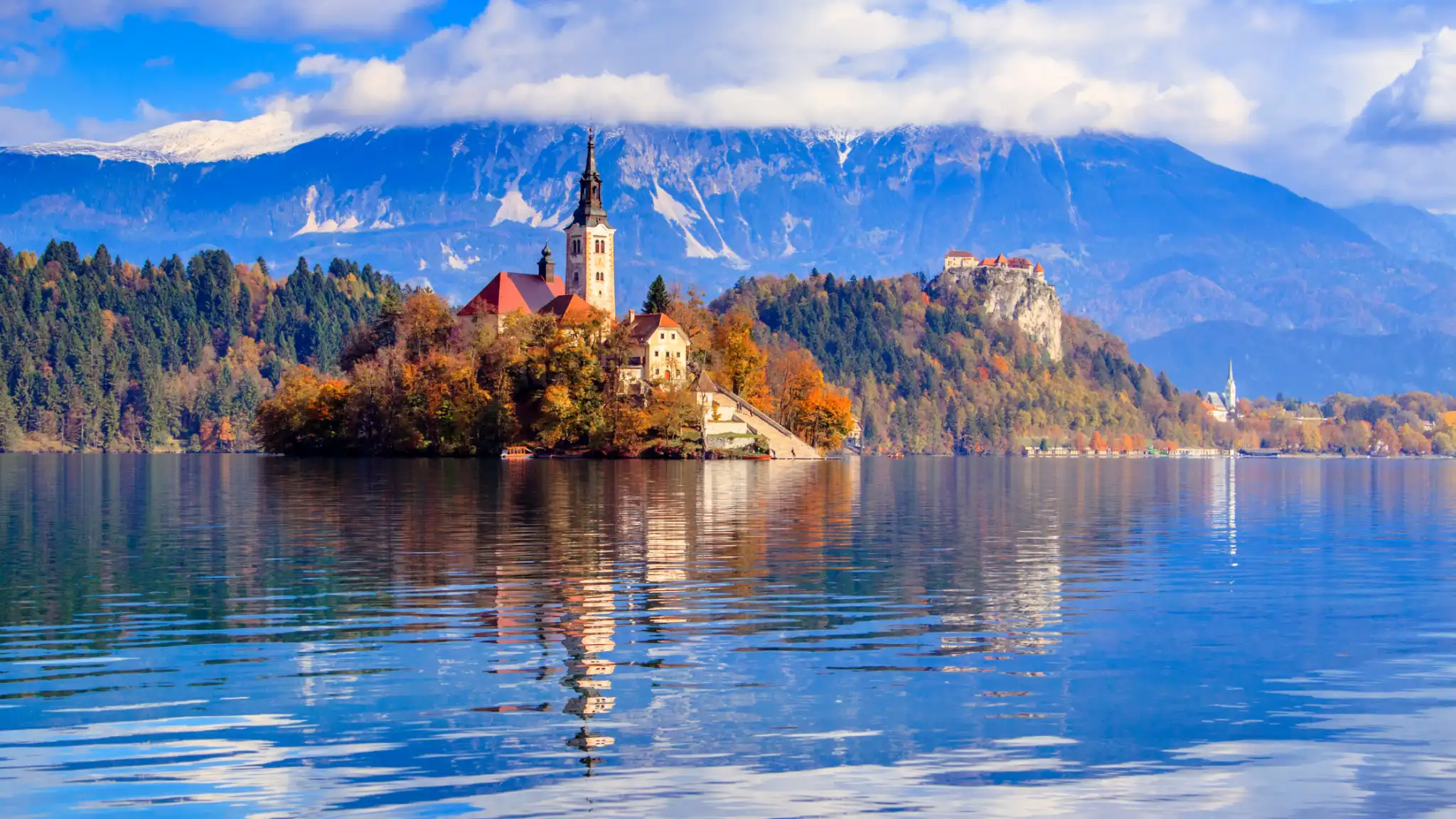 View of Lake Bled with Bled Island in the foreground and Bled Castle in the background, a picturesque setting for a Lake Bled wedding.