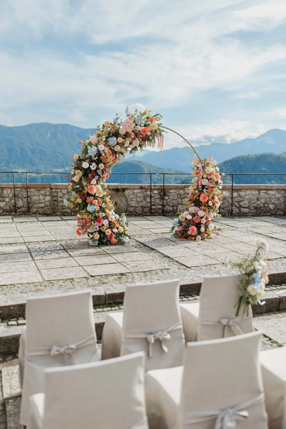 Bled Castle wedding ceremony setup in the upper courtyard with panoramic mountainviews