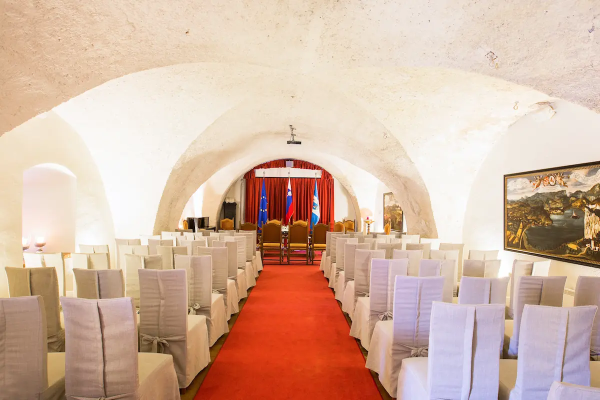 Knights Hall at Bled Castle elegantly decorated for a wedding reception