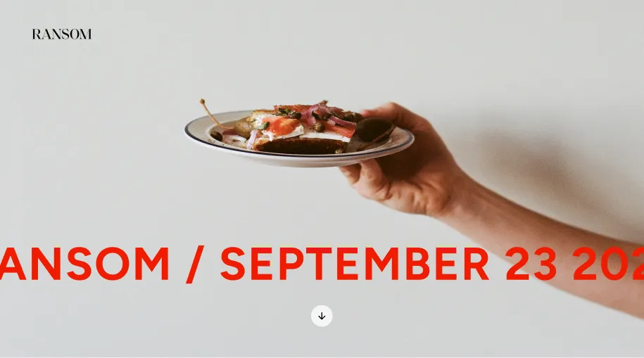 A hand holds a small plate with a piece of bread topped with smoked salmon, capers, and herbs against a plain light background, with the text 'RANSOM / SEPTEMBER 23 2021' partially visible in large red letters.
