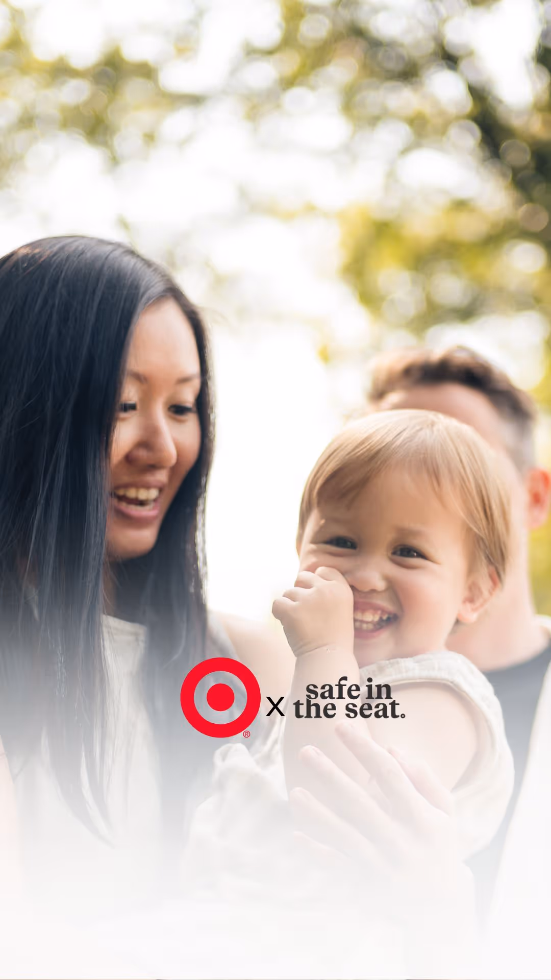A woman holding a baby and smiling 