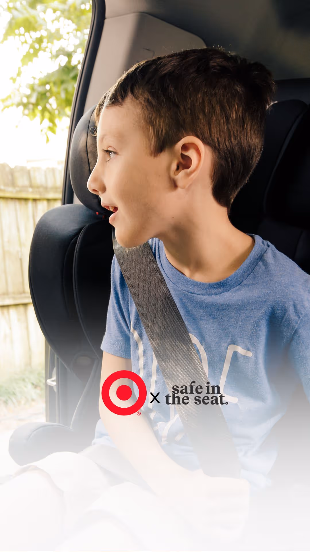 A young boy sitting in the back seat of a car. On this image is a Target and Safe in the Seat Logo. 