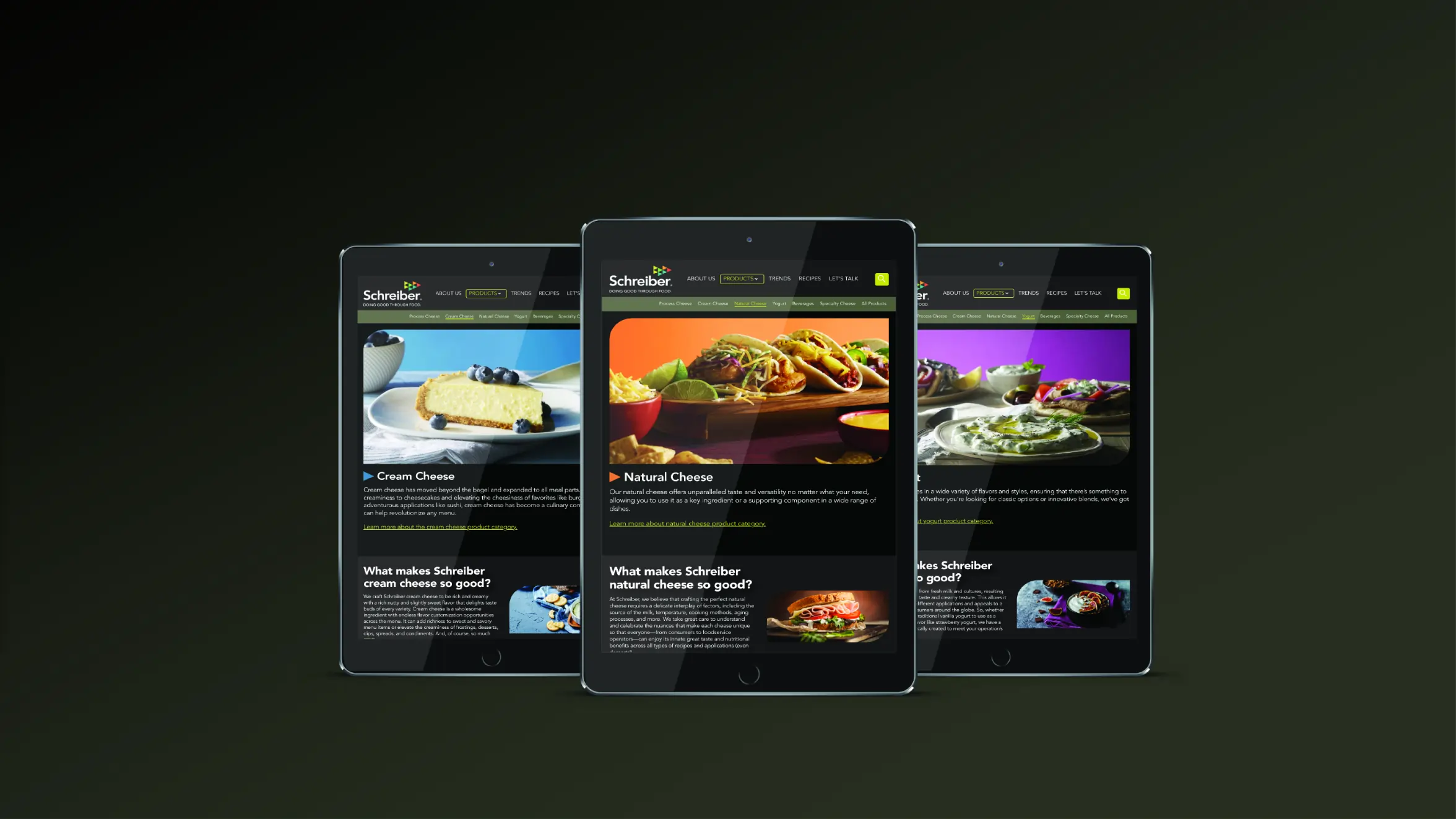Three tablets display different web pages featuring cheese dishes: a cheesecake, stuffed peppers, and a salad, all on a dark background. The screens show Schreiber branding and headings about cream cheese and natural cheese.